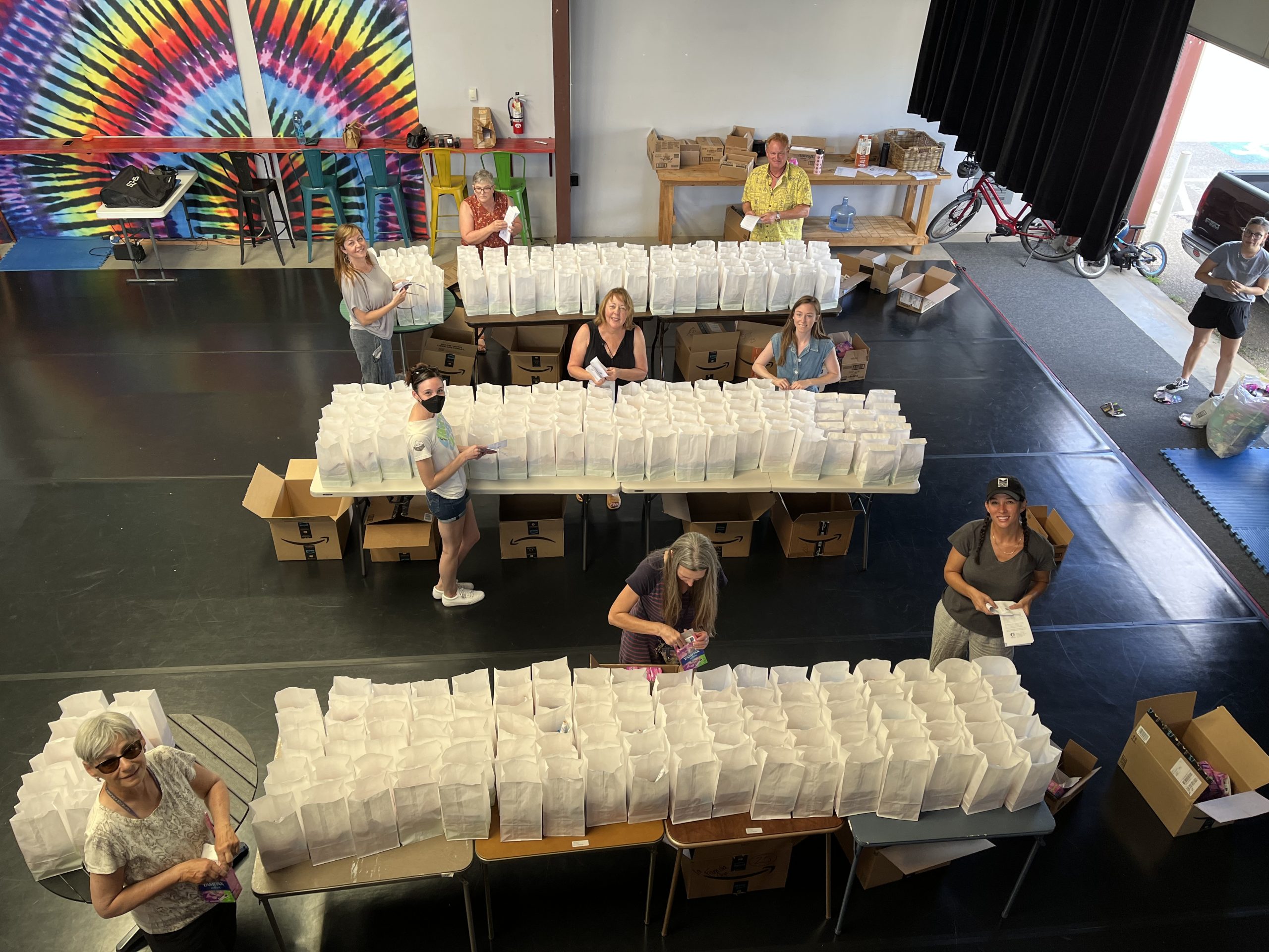Overhead view of volunteers putting together 300 period kits